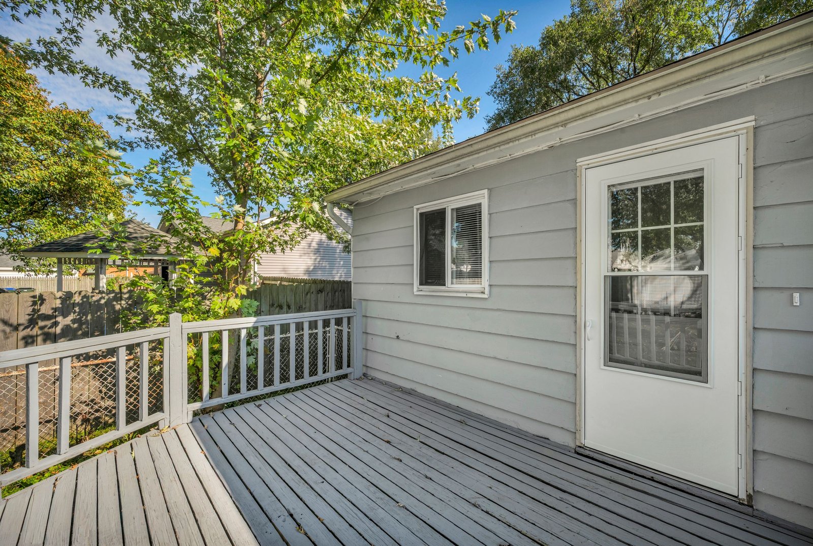 Refinished wood deck with new railings after deck restoration - Homex Builders