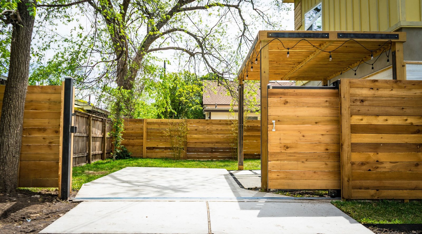 New wood privacy fence and gate installed in a backyard - Homex Builders
