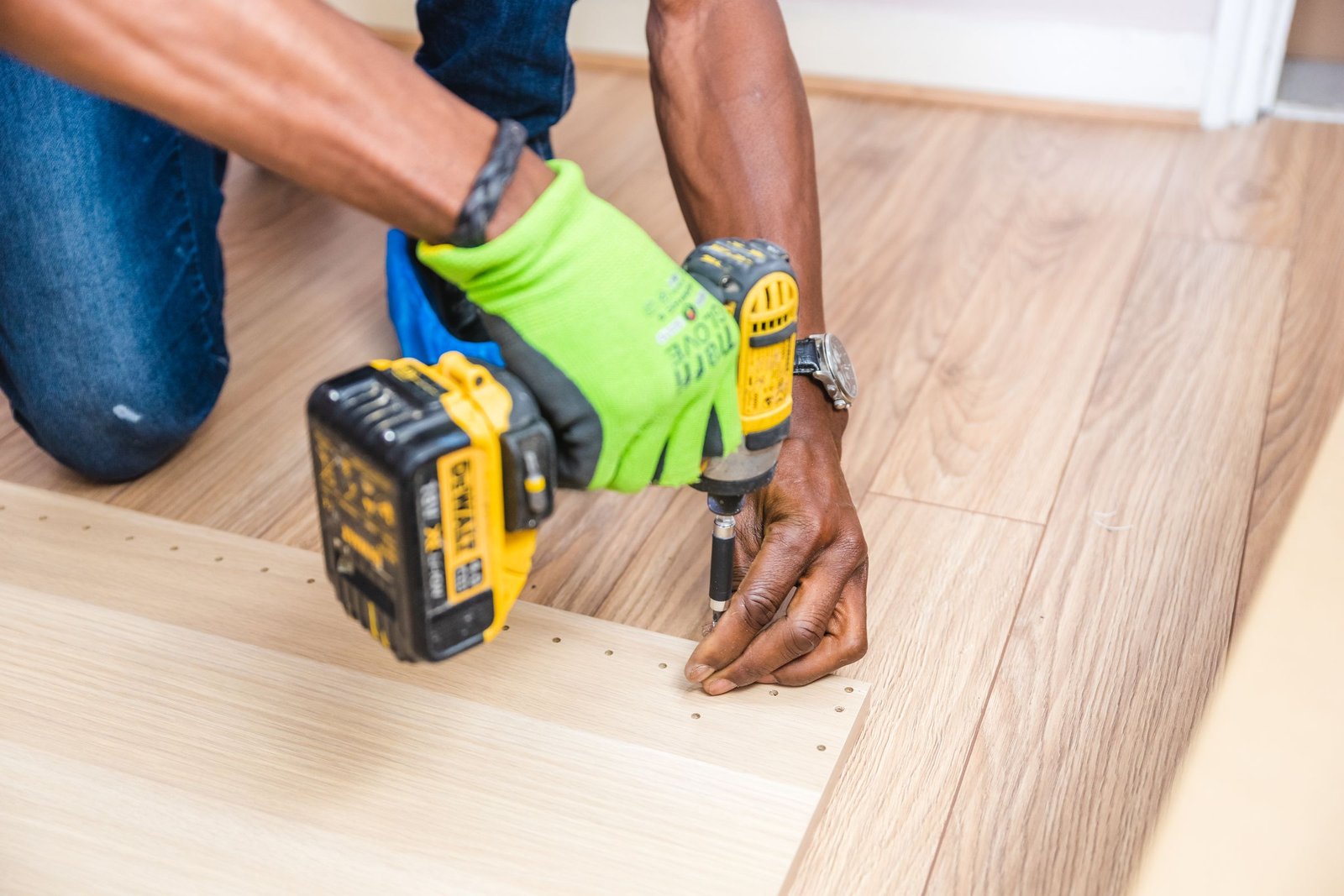 Flooring installer fastening new floor boards during flooring installation in NYC - Homex Builders